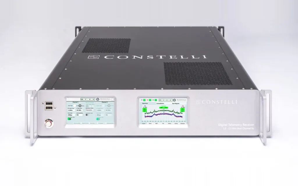 Constelli's rack-mounted digital telemetry receiver, its two front-panel touchscreens showing channel settings and a live signal spectrum